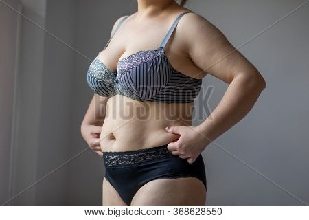 Woman Real Body Plus size Model in lingerie posign, imperfect nonideal