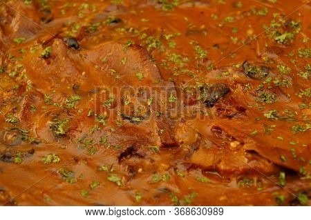 Pork Steak With Brown Sauce And Parsley Leaves