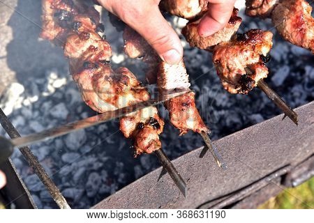Cooking Meat On The Grill. Fried Food Over Charcoal. Barbecue Weekend. Meat Languor At Low Temperatu