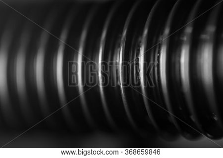 A Close-up Of The Thread Of A Black Bolt With Whitening Ribs Of A Spare Part In An Auto Service As A