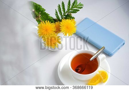 Morning Tea With Sweet Lemon Candy And Light Blue Mobile Phone, Bouquet Of Yellow Spring Dandelion F