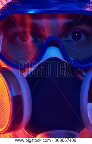 COVID-19 or 2019-nCoV. Close-up portrait of a scientist microbiologist in respiratory mask. Pandemic.
