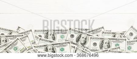 Top View Banknotes On Colored Desk With Copy Space On Top. One Hundred Dollar Bills With Stack Of Mo