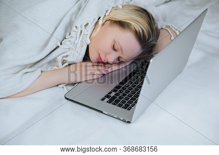 Young White Woman Is Sleeping On Her Laptop Keyboard After Watching Some Tv Series.