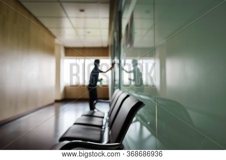 Blurred Image Of Housekeeper Cleaning Service Working At Office. Blur Image Use For Background.