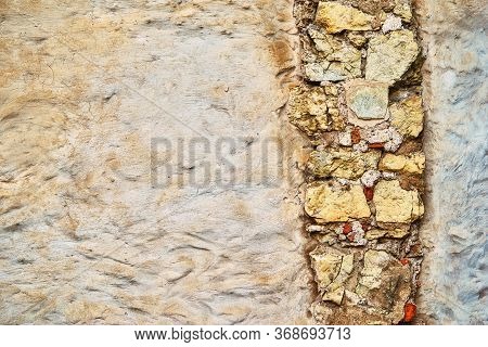 Empty Surface Of Old Plastered Wall For Background With Textured Vertical Piece Of Masonry