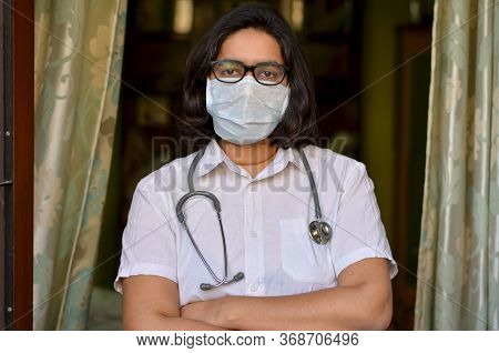 Portrait Of Young Medical Healthcare Female Worker With Hands Crossed / Folded, Stethoscope Over Her