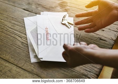 Expressive Hands React To An Overdue Letter In An Envelope - Financial Hardship - Crisis