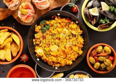 assorted of spanish dish- paella, mussel, tapas