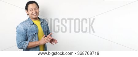 Young Asian Man Wearing White Shirt, Happy Proud Clapping Gesture.over Grey Background, Halfl Body P
