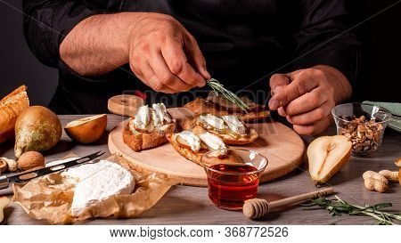 Chef Preparing Cheese, Pear Bruschetta In The Kitchen. Elicious Breakfast Or Snack With Brie Camembe