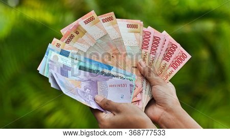 The Girl Is Holding Indonesian Money. Indonesian Rupee.