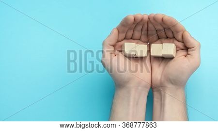 Wooden Cubes In Men's Hands Close Up. Business Concept For Growth Success Process. Copy Space