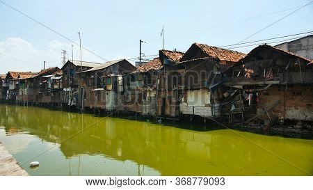 Slum Area On The Riverbank In Jakarta. Indonesia.