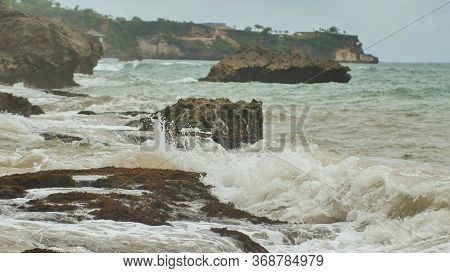 Slow Mtion Stony And Rocky Shore With Strong Waves And Wind Near Bali Island. Tegal Wangi Beach. Ind