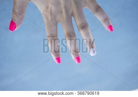 Womans Hand Showing Her Semipermanent Manicure. Pink Colour