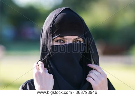 Portrait Of A Muslim Woman In Black Clothes. Islamic Woman In National Dress, Close-up Black Clothes
