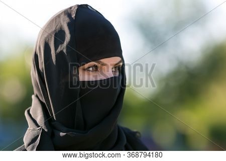Portrait Of A Muslim Woman In Black Clothes. Islamic Woman In National Dress, Close-up Black Clothes