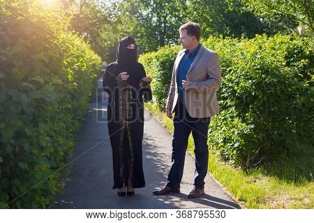The Friendship Of A European Man And A Muslim Woman. A Date Of An Adult Caucasian Man And A Young Is