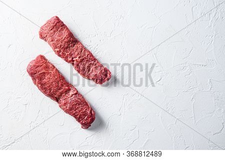 Raw Set Of Denver, Machete Steak On A White Stone Background Space For Text.