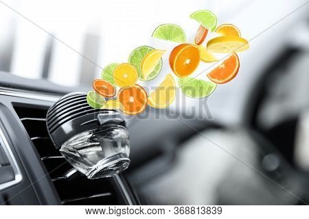 Air Freshener Clip Attached To Car Ventilation. Citrusy Aroma