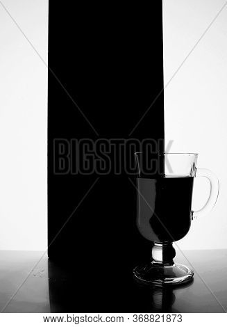 Red Glass With Liquid On A Black White Background. Stylish Black And White Photo