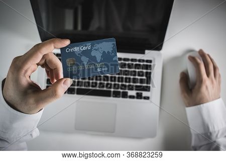 Hands Holding Credit Card And Using Laptop. Online Shopping