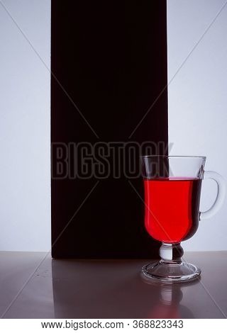 Red Glass With Red Liquid On A Black White Background. Stylish Photo