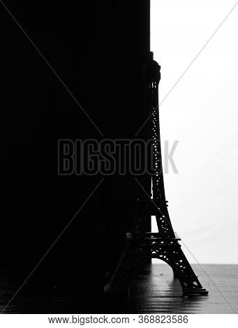 The Silhouette Of The Eiffel Tower Figurine On A Black White Background