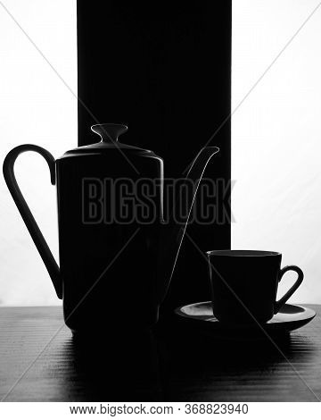 Concept Kettle And Cups With Saucer On A Black White Background