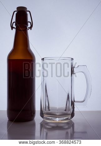 Colored Silhouette Of A Beer Bottle With A Cork And Beer Mug On A Black White Background