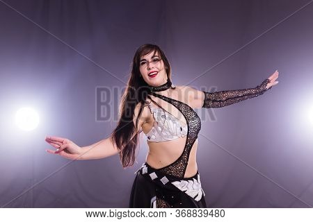 Girl Dancing Belly Dance, Fusion Or Tribal. A Woman In A Beautiful Costume Demonstrates Charming And