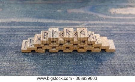Scandinavian Wooden Runes On An Old Wooden Table. Elder Futhark.