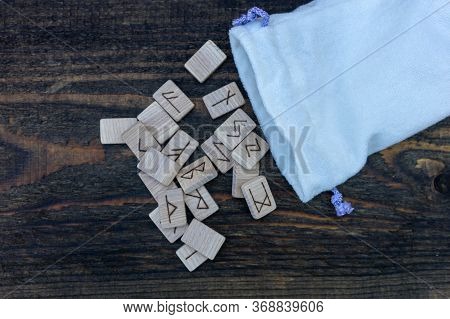 Scandinavian Wooden Runes On An Old Wooden Table. Elder Futhark.