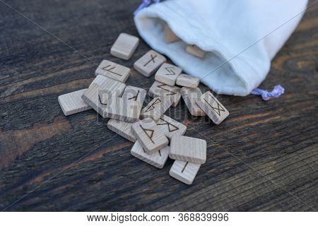 Scandinavian Wooden Runes On An Old Wooden Table. Elder Futhark.