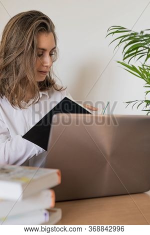 Woman Working On Laptop At Home Office While Drinling Coffee. Web Conection