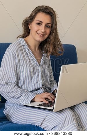 Woman Working On Laptop At Home Office While Drinling Coffee. Web Conection
