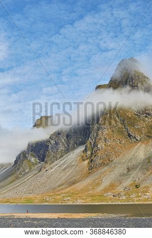 Foggy Mood. Amazing Shot Of Impressive Eystrahorn Mountain Chain In Iceland With Fog Rings Around, B