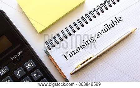 Notebook With The Inscription, Calculator, Pen Lying On A White Table