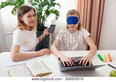 Mother Helping Teenage Daughter To Learn Touch Typing On Keyboard, Girl Is Typing With Closed Eyes W