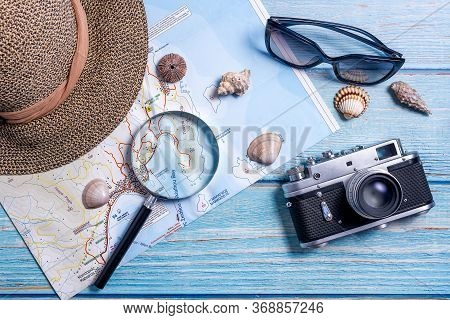 Top View Of Planning Vacation Planning Using A Map, Magnifier, Retro Camera - Travel Influencer Look