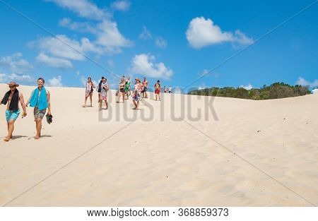Fraser Island Australia - March 13 2014; Tourists Walking Through Sand Of Lake Wabby Sand Blow