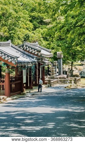 Haeinsa-gil, South Korea; May 26, 2020: Unidentified Man Pauses To Read Information Posted At Entran