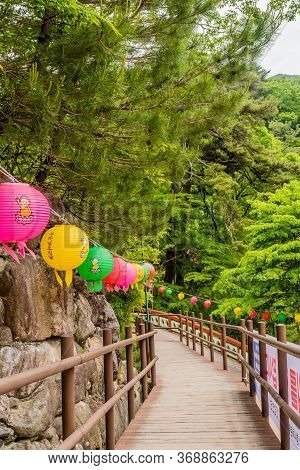 Haeinsa-gil, South Korea; May 26, 2020: Wooden Walkway Lined With Colorful Paper Lanterns At Haeinsa