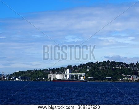 Seattle, Washington, Usa - May 18, 2019: Cargo Ship Loads Up At Grain Silo At Louis Dreyfus Corporat