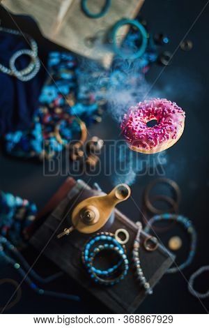 Genie Lamp With A Pink Donut As A Fulfilled Wish, Sweet Tooth Concept, Magical Food Photo