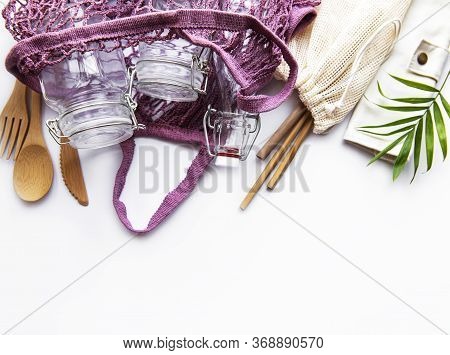 Cotton Bags, Net Bag With Reusable  Glass Jars, Bamboo And Wooden Cutlery On White Background. Zero 