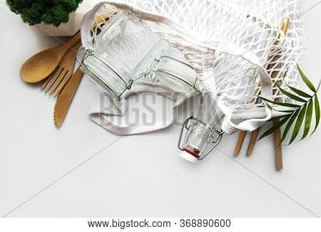 Cotton Bags, Net Bag With Reusable  Glass Jars, Bamboo And Wooden Cutlery On White Background. Zero 