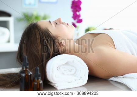 Girl In Towel Lies At Reception Massage Therapist. Way To Improve Your Health And Well-being. Reliev