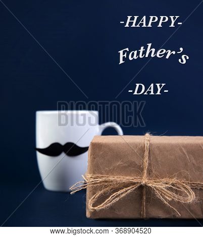 Happy Fathers Day Concept. Cup Of Coffee With Black Paper Mustache, Gift.
